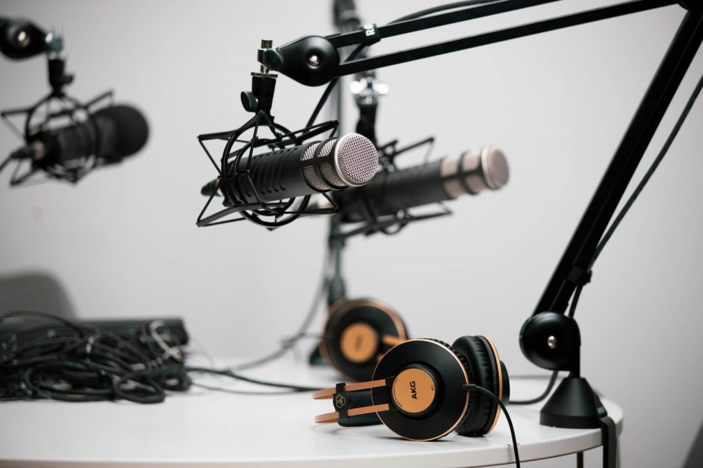 A podcasting setup with a microphone, headphones, and audio equipment.